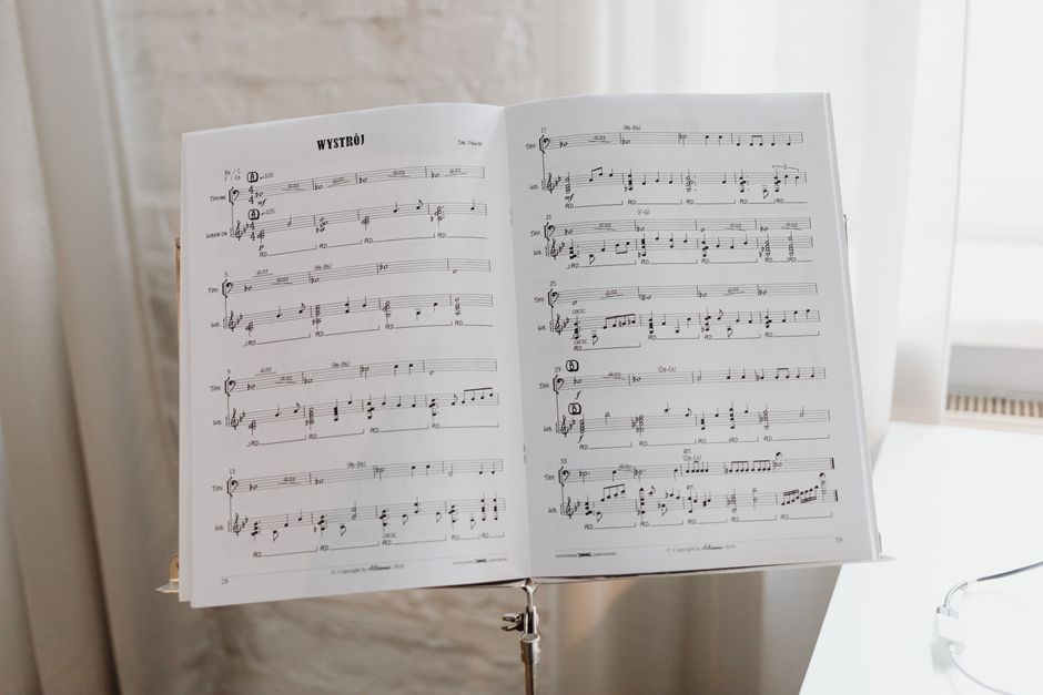 Elegant sheet music on a stand with soft natural light pouring through the window.