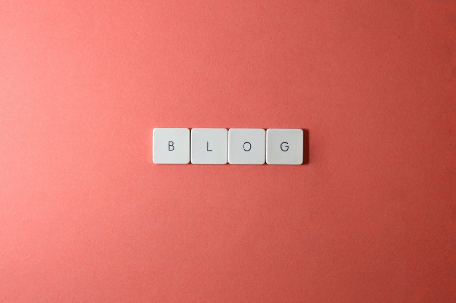 A minimalist image of keyboard keys spelling 'BLOG' on a coral background.