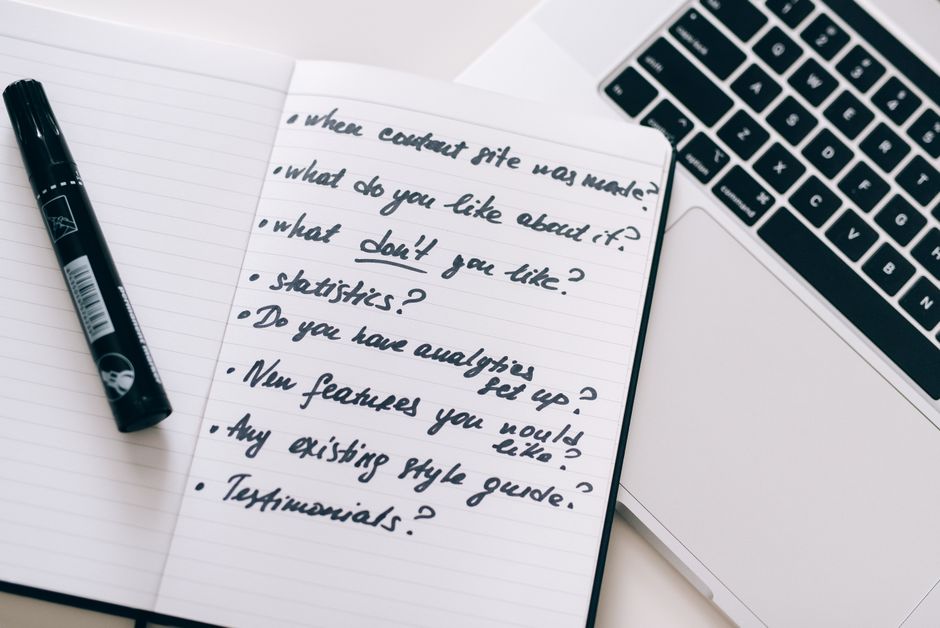 Close-up of a notebook with handwritten notes next to a laptop, ideal for business or educational content.