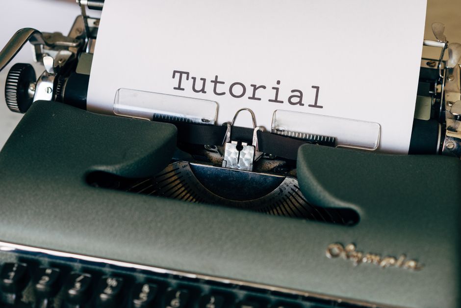 Close-up of a vintage typewriter with a sheet reading 'Tutorial'. Ideal for writing themes.