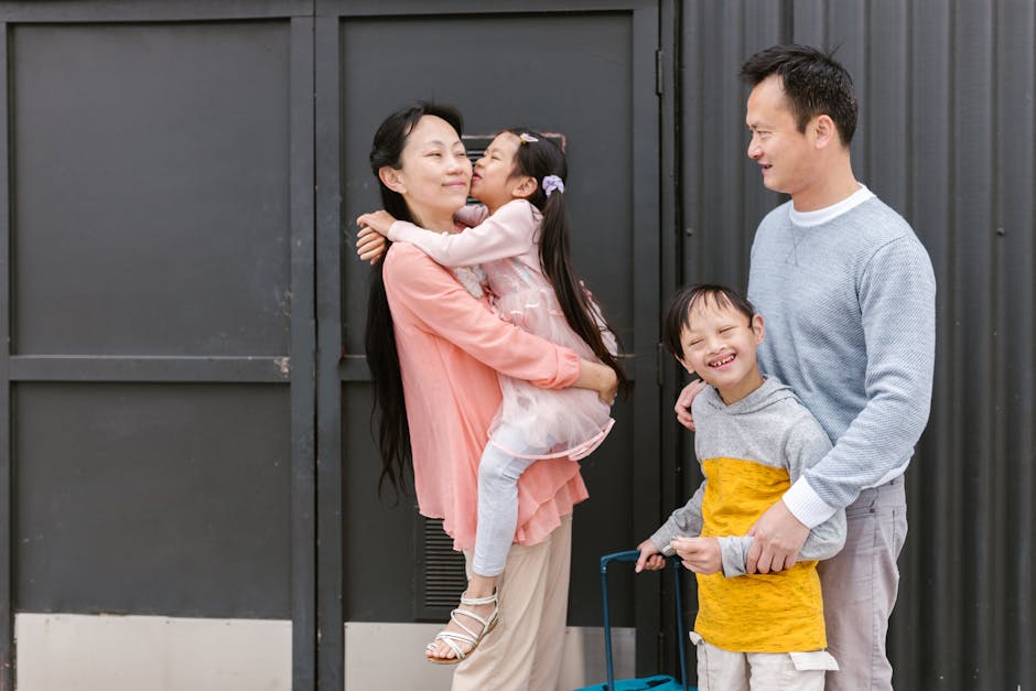 Asian family embracing and enjoying time together outdoors, showcasing love and inclusion.