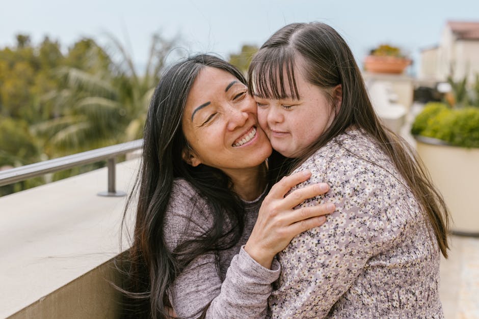 Loving mother embraces her daughter with Down syndrome, showcasing affection and happiness.